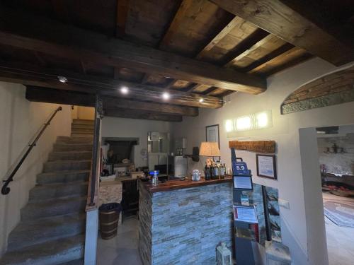a room with a staircase and a stone wall at Tenuta dei Cavalieri in Molino del Piano