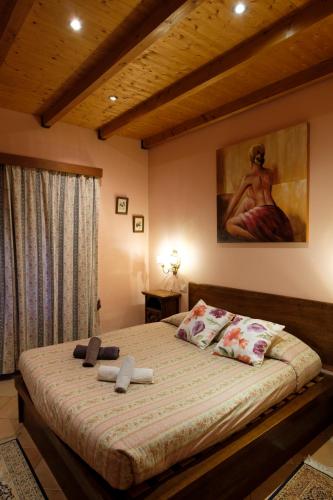 a bedroom with a large bed with a painting on the wall at Tenuta dei Cavalieri in Molino del Piano