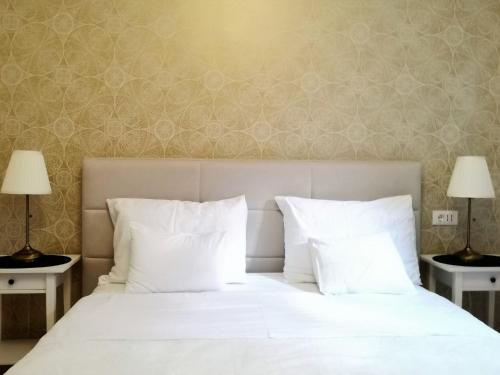 a bedroom with a white bed with two lamps at Accommodation Maria Di, Free Parking, Sea View in Dubrovnik