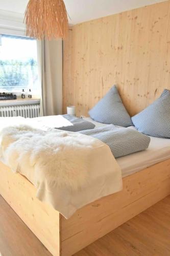 a bedroom with a bed with a wooden frame at Chalet in Ühlingen-Birkendorf