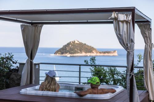 a man and woman sitting in a bath tub at Baba Residences in Alassio