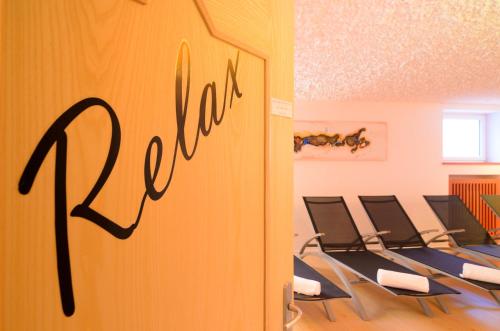 a row of chairs in a room with a waiting room at Landhotel Latscherhof in Laces