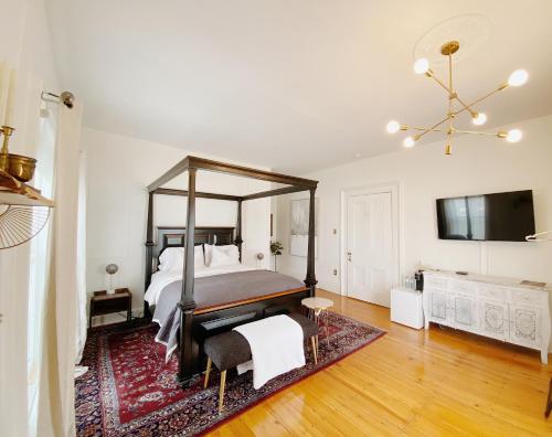 una camera da letto con un grande letto e un grande specchio di The Montague Rose Inn & Cafe a Saint Andrews