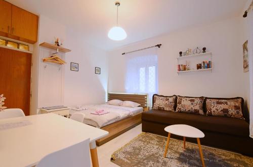 a small living room with a couch and a bed at Old Town Experience - Studio Apartment in Budva