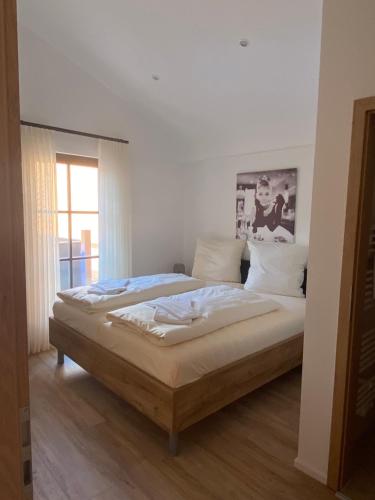a large bed in a room with a window at Der Limes Kipfenberg in Kipfenberg