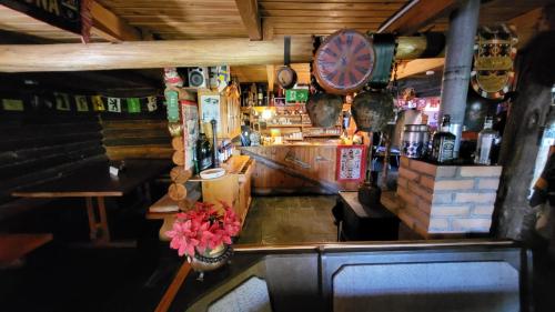 a bar with a counter with a clock on the wall at Cabañas swissminiatur in Cacheuta