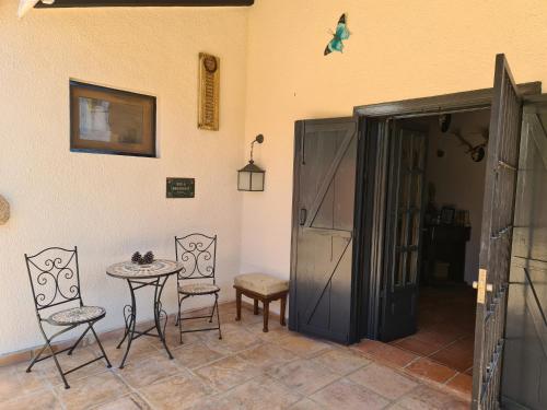 a room with a table and chairs and a door at B&B Finca la Yuca "Un paraíso en Ontinyent" in Ontinyent