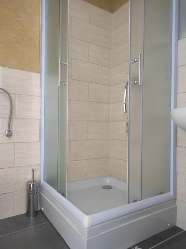 a shower with a glass door in a bathroom at Prenoćište Ljiljana 2 in Livno