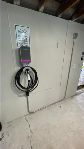 a cell phone is plugged into an electrical box at Perfect Location Walk to MSU Campus High End Mattresses Fast Wi-Fi in East Lansing