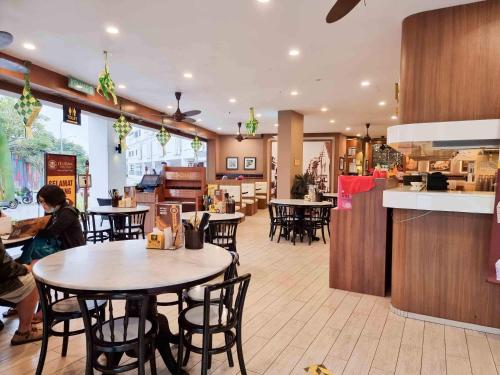 a restaurant with tables and chairs in a room at Mossy Forest Family Retreat, Kea Farm Brinchang in Brinchang