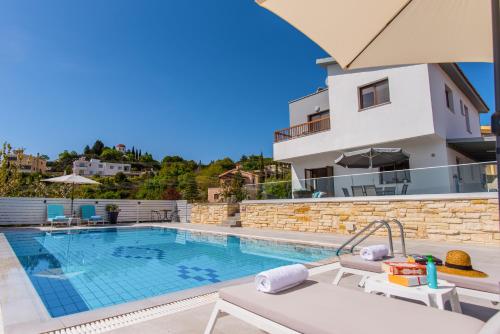 a villa with a swimming pool and a house at Alkiviades Villa in Theletra