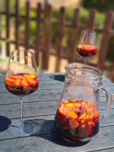 two wine glasses with fruit in them on a table at B&B Finca la Yuca "Un paraíso en Ontinyent" in Ontinyent
