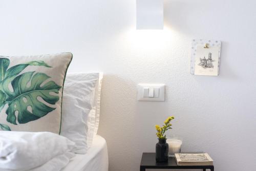 a bedroom with a bed with a pillow and a table at Sun Garda in Ponti Sul Mincio