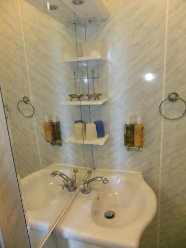 a bathroom with a sink and a mirror at Elgin Villa in Bath
