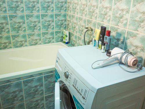 a washing machine in a bathroom next to a bath tub at Modern Room With A Great Sunrise - close to the center - in Timişoara