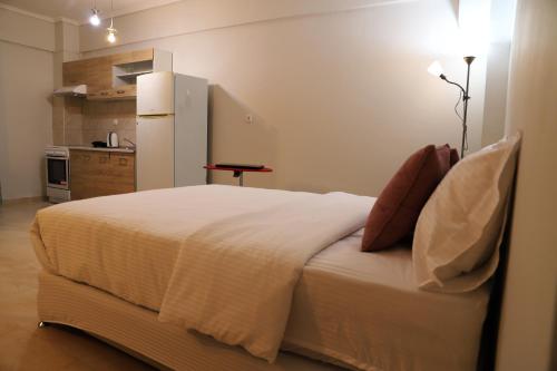 a bedroom with a large bed with a refrigerator at New Stylish and Cozy Apartment in Kráni