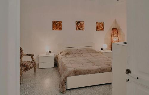 a bedroom with a bed and two pictures on the wall at Appartamenti Luxury Greco in Brindisi