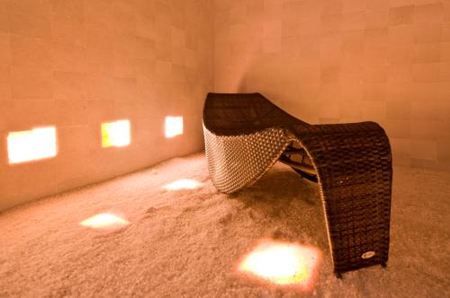 a room with a wicker chair in the corner at Hotel Warmia Spa in Braniewo