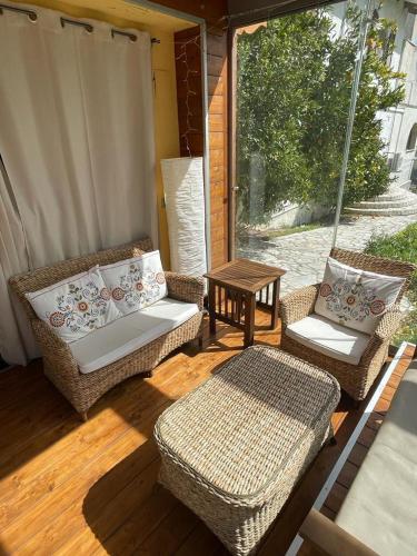 a porch with two wicker chairs and a table at Frapippo in Chieti