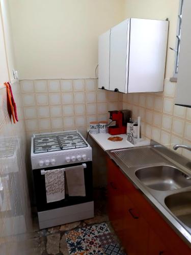 a small kitchen with a stove and a sink at La Casa delle Zie in Maglie