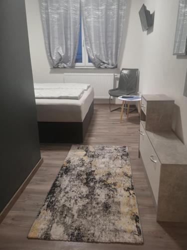 a bedroom with a bed and a rug at Pension Forstfeld Kassel in Kassel