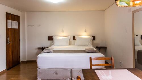 Ένα ή περισσότερα κρεβάτια σε δωμάτιο στο Hotel Chalet Monet - Granja Vianna