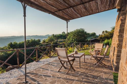 a group of chairs and a table on a patio at Nikis Resort in Gubbio