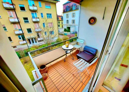 a balcony with a table and chairs on a balcony at Large Apartment Bern City Centre in Bern