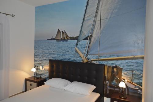 a bedroom with a sail boat in the water at Apartments Ponta in Kotor