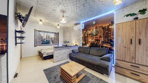 a living room with a couch and a table at Apartament Dubaj in Bytom