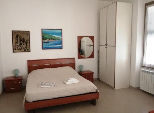 a bedroom with a bed and a refrigerator at Casa Minù in La Spezia