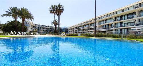 a large swimming pool in front of a building at Apartamento Dénia Beach by DENIA COSTA in Denia