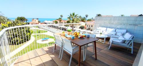a patio with a table and chairs on a balcony at Apartamento Dénia Beach by DENIA COSTA in Denia