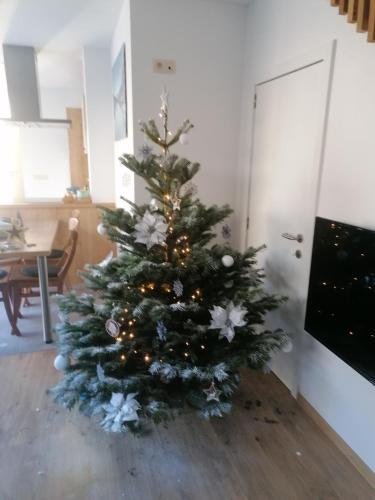 a christmas tree sitting on the floor in a room at Les hauts de Meez in Dinant