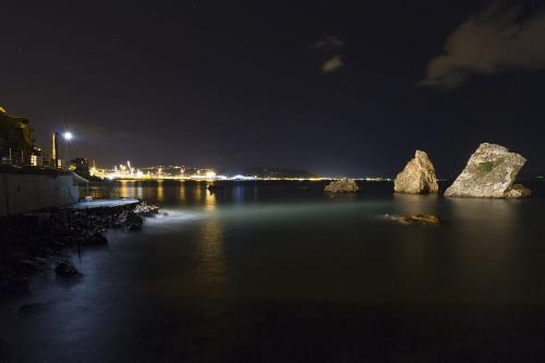 a view of a river at night with rocks in the water at ELISA Dependance Centro in Vietri sul Mare