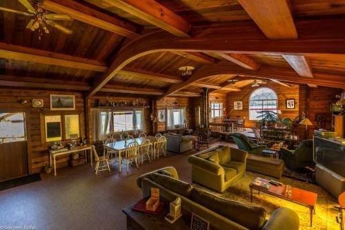 a living room with couches and chairs in a building at Alert Bay Lodge in Alert Bay