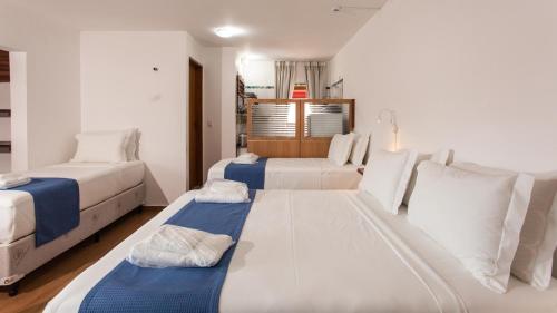 Ένα ή περισσότερα κρεβάτια σε δωμάτιο στο Hotel Chalet Monet - Granja Vianna