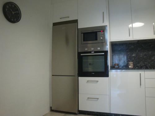 a kitchen with a refrigerator and a microwave at Piso en Alexandre Bóveda in O Grove