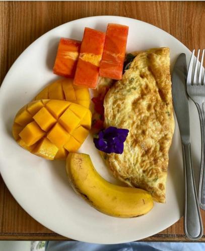a plate of breakfast food with eggs and fruit at GREENSPACE in Panglao