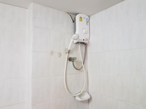 a shower in a bathroom with a shower head at Punya Garden Hotel in Ban Wang Won