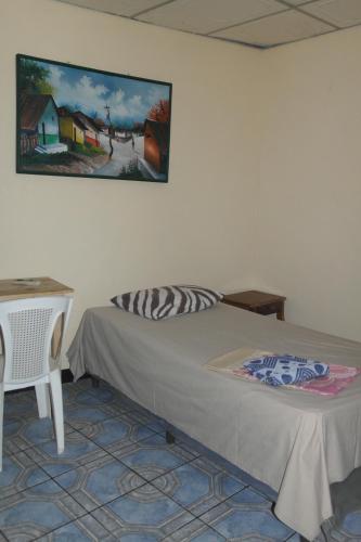 Hostal Nicaragua Guest House tesisinde bir odada yatak veya yataklar