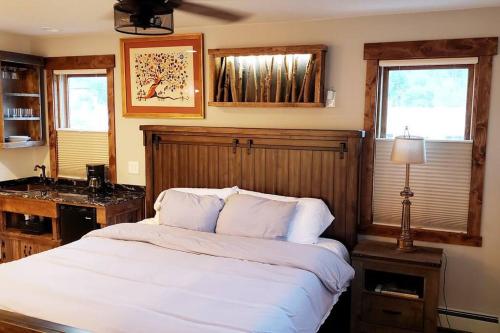 a bedroom with a large white bed and a sink at Clear Creek Inn in Georgetown