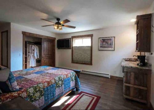 a bedroom with a bed and a ceiling fan at Clear Creek Inn in Georgetown