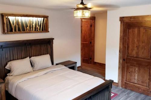 a bedroom with a large bed with a wooden headboard at Clear Creek Inn in Georgetown