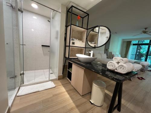 a bathroom with a sink and a shower at Sea Passion Hotel in Koror