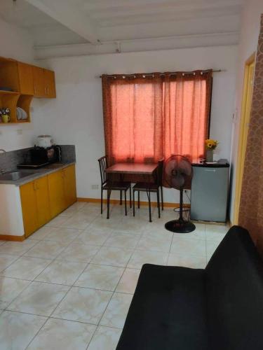 a kitchen with a table and chairs in a room at Sunmiles Condominium in Calamba