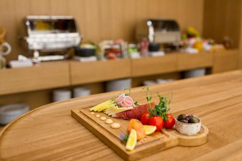 a tray of fruits and vegetables on a table at Hotel Bono in Budva