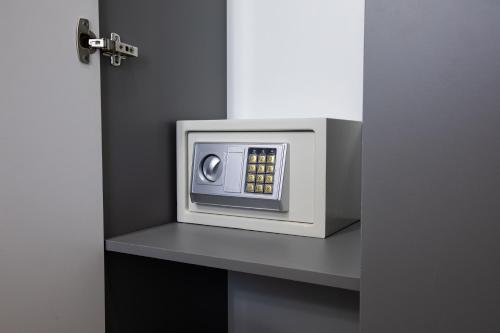 a microwave oven sitting on a shelf in a room at Hotel Irtysh in Ustʼ-Kamenogorsk