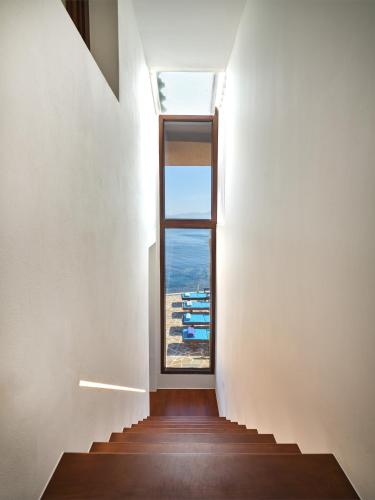 a staircase leading up to a window in a house at Forecastle in Keratea