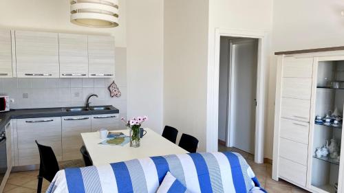a kitchen with a table and chairs in a kitchen at Attici con Terrazzo vista Mare in Calasetta